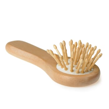Wooden hairbrush. It is isolated on a white background