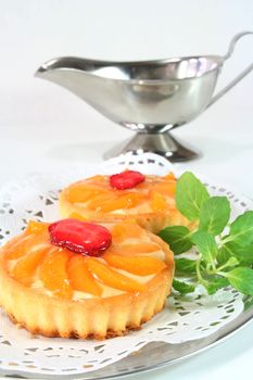 Apricot tart with lemon balm on a silver platter