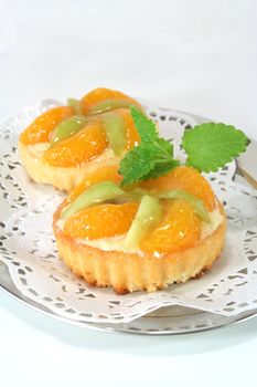 Mandarin tartlet with lemon balm on a silver platter