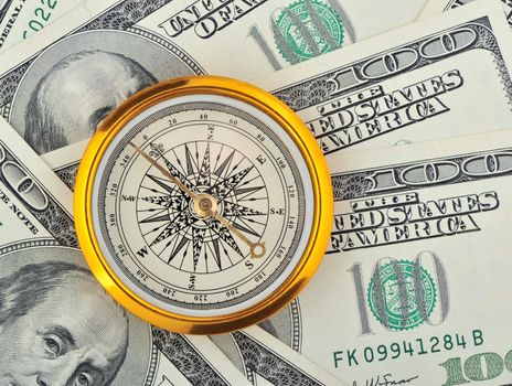 Dollars and compass. Concept about a direction in business