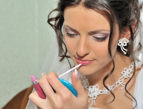 The bride making up. The young girl in a wedding dress.