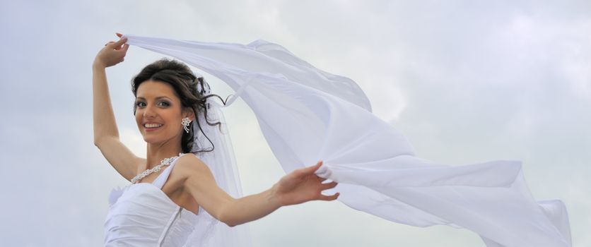 The bride with a fluttering veil. The young girl in a wedding dress.