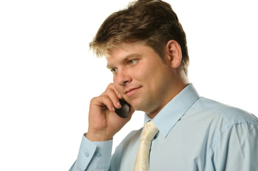 The businessman talking by a mobile phone. Young the man of the European appearance
