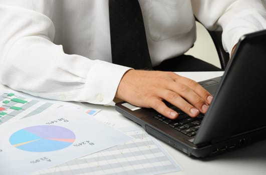 Hands of the businessman above the keyboard laptop