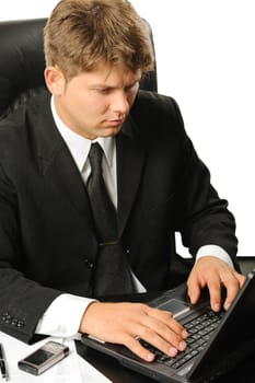 The young businessman on a workplace. It is isolated on a white background