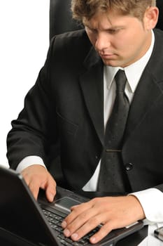 The young businessman on a workplace. It is isolated on a white background