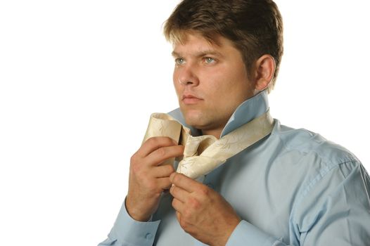 The man fastening necktie. Young the man of the European appearance