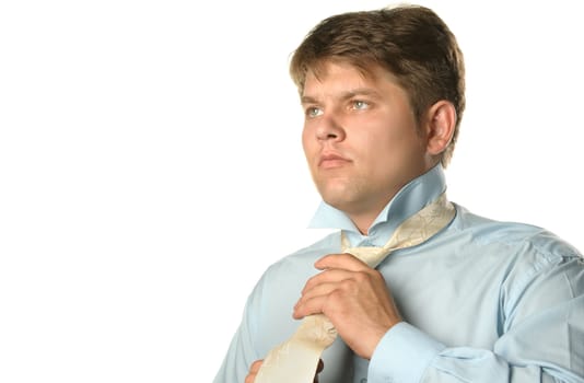 The man fastening necktie. Young the man of the European appearance