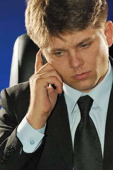 The businessman talking by a mobile phone. Young the man of the European appearance