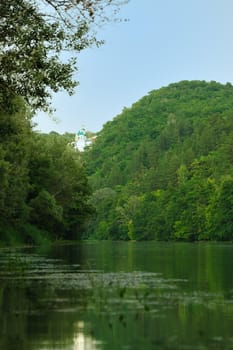 Picturesque forest and the river. Small river at bottom of mountain with mixed by a wood in the East Europe. Ukraine.