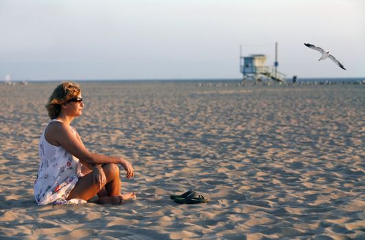 The adult woman on a coast of ocean. Los Angeles. Santa Monika, Venice Beach