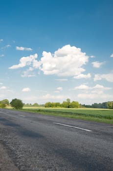 Road. An automobile line and the bright dark blue sky