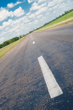 Road. An automobile line and the bright dark blue sky