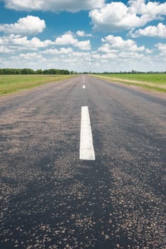 Road. An automobile line and the bright dark blue sky