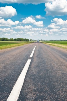 Road. An automobile line and the bright dark blue sky