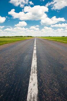 Road. An automobile line and the bright dark blue sky