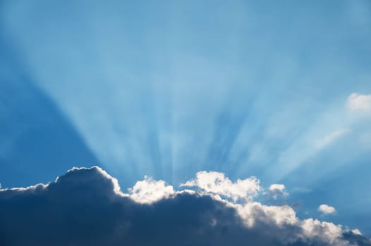 Cloud and beams of the sun. A greater thundercloud and beams of the sun because of it