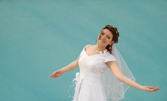 The dancing bride. The young girl in a wedding dress on an abstract background. East dance