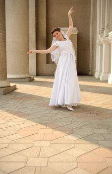 The dancing bride. The young girl in a wedding dress. East dance