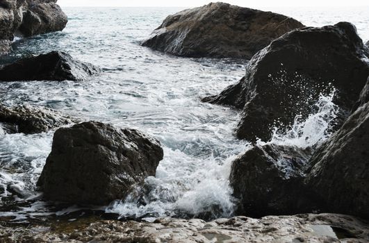 Splash of waves about coastal stones. Crimea, Ukraine
