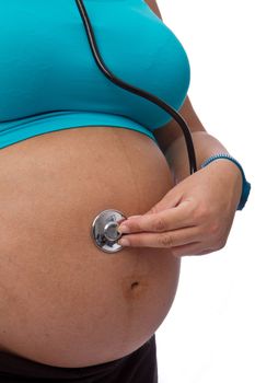 Pregnant woman hear with a stethoscope isolated on white