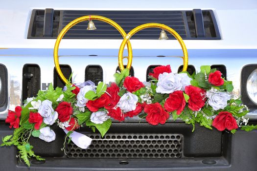 Wedding wreath decoration in heart shape on white car