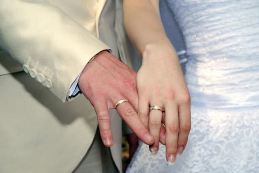 Hands of the groom and the bride with rings