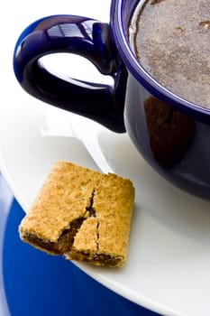 Wheat fig bar with coffee on white saucer