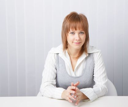 blue-eyed happy attractive young businesswoman in office
