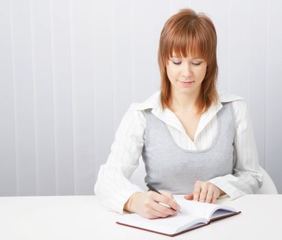 Girl with a notebook in the office. Business concept

