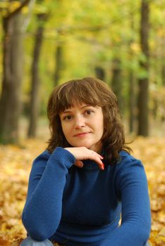 The girl on a background autumn forest. Age - 26 years