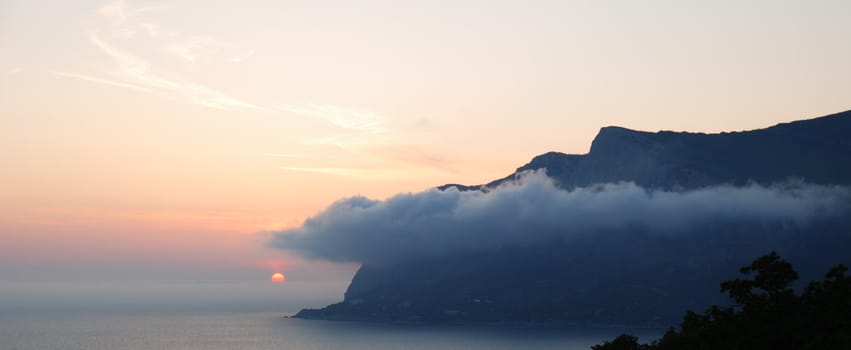 Sunset. A picturesque sunset with fantastic foggy under mountain