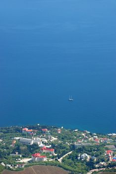 City at the sea. A small vessel in the high sea