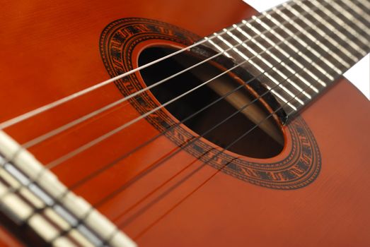 Acoustic six-string guitar. Covered by a brown varnish 