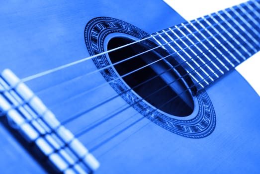 Acoustic six-string guitar. Covered by a brown varnish 