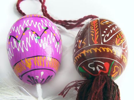 Easter eggs painted by bright paints   - with the passed cords (handmade) - isolated white background  - with the passed cords