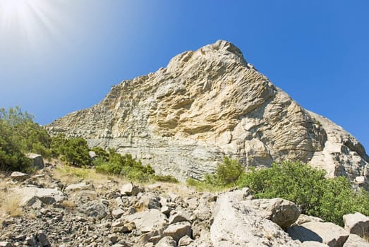 Fragment of the big rock on a background of the sated dark blue sky