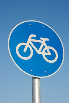 Bicycle road sign against clear blue sky