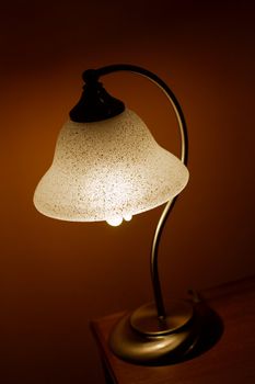 Small lamp glowing in a dark room