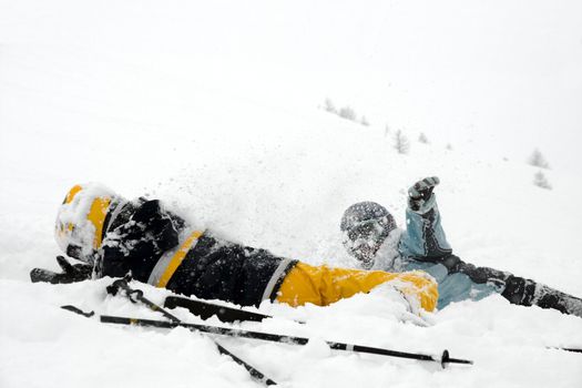 Skiers girls playing in the snow