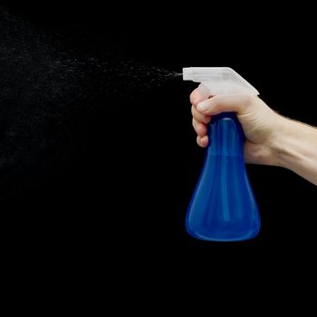 Sprayer in hand isolated on a black