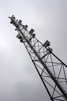 High transmitter tower against overcast sky