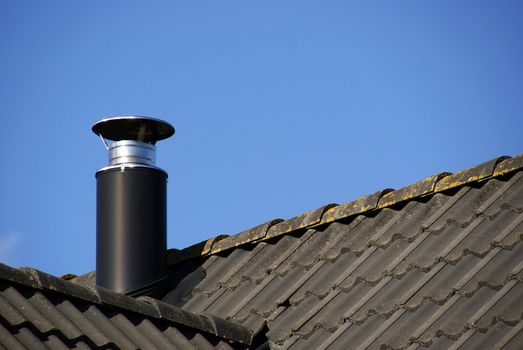 Pipe of ventilation on a roof of tiles