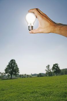 electric bulb against the sun as a symbol for solar energy