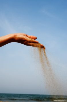 sand running through hands as a symbol for time running, lost etc.............