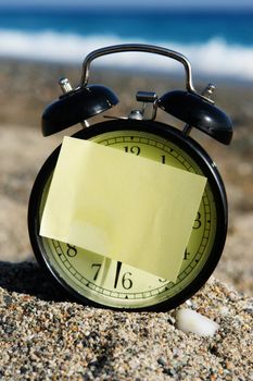 a closeup of an old clock on a beach