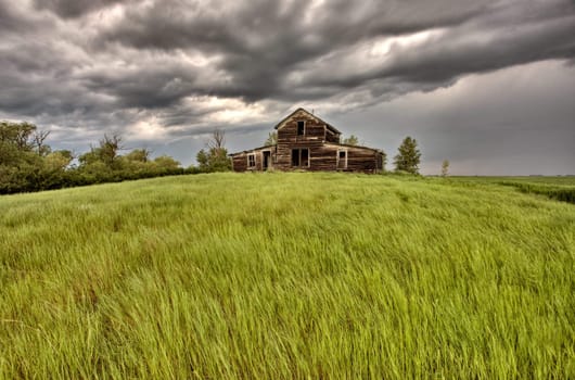 Abandoned Farm Buildings Saskatchewan Canada Storm clouds Prairie