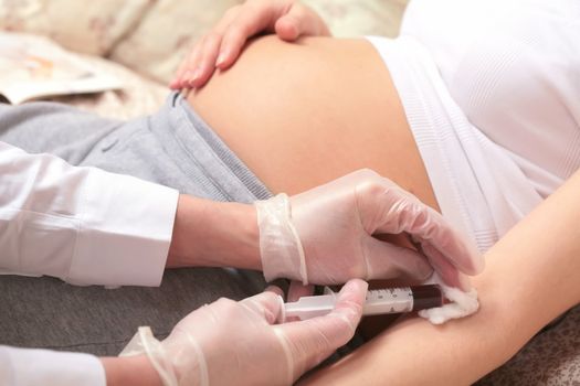 pregnancy, control blood in a laboratory, hands of the doctor with syringe