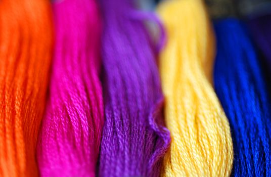 A close-up of bright and colourful sewing threads