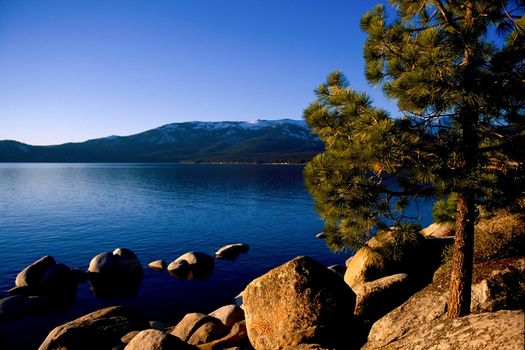 Lake Tahoe is a large freshwater lake in the Sierra Nevada mountains of the United States. It is located along the border between California and Nevada, west of Carson City, Nevada. The lake is known for the clarity of its water and the panorama of surrounding mountains on all sides.